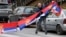A man holds Serbian flags in North Mitrovica, Kosovo, following local Serbs' decision to quit their jobs in Kosovar institutions in November 2022.