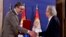 Austrian author Peter Handke, right, receives the Order of the Serbia from President of Serbia Aleksandar Vucic during the ceremony in Belgrade, May 9, 2021. 