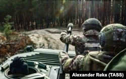 Russian volunteers ride an armored personnel carrier in the Donetsk region in November 2023.