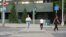 Kazakhstan - a woman crossing street. Astana, 17 July 2023