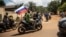Supporters of a coup in Burkina Faso wave a Russian flag in October 222.
