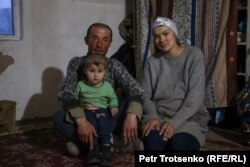 Zhamlika, his wife Maryam, and their young son at home in their winter hut.