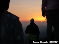 Members of the White Brotherhood watch the sun rise on August 18.