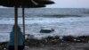 A woman looks at a car floating in the sea in the town of Tsarevo, on Bulgaria's Black Sea coast. on September 6.<br />
<br />
At least two men have died, and a search for a mother and child continues following <a href="https://d248ijkgwbbf5u.cloudfront.net/a/dvama-muzhe-zaginali-pri-navodneniata-carevo/32580506.html" target="_self">torrential rains</a> that caused widespread flooding in the region.