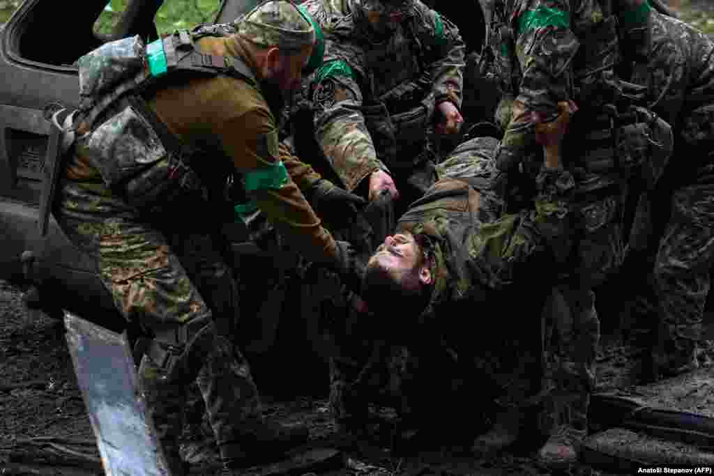 Ukrainian soldiers carry an injured comrade. Kyiv admits that its forces have paid a heavy price defending "Fortress Bakhmut," a city that held around 70,000 people before the Russian invasion.&nbsp;