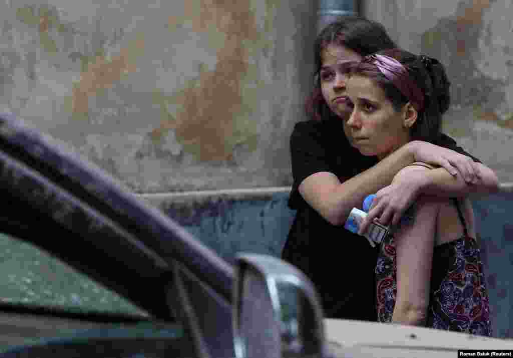 Local residents react at the site of the missile strike. Ukraine&rsquo;s Air Force reported intercepting seven of 10 cruise missiles that Russia fired from the Black Sea toward the region of Lviv at around 1 a.m.