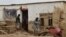 Afghan men clear debris and mud from a damaged house after a flash flood caused by heavy rainfall in Laqiha village of Baghlan-e Markazi district in the northern Baghlan Province on May 11.