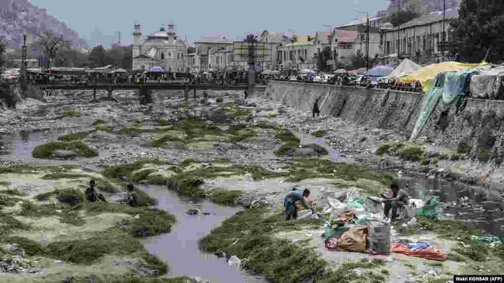 Ragpickers besides a stream along the Kabul River in Kabul. Since the Taliban takeover of Afghanistan in August 2021, the country has been gripped by an economic meltdown. Around half of Afghanistan&#39;s 40 million people are &quot;acutely food insecure,&quot; according to the UN, with 6 million on the brink of starvation.&nbsp;