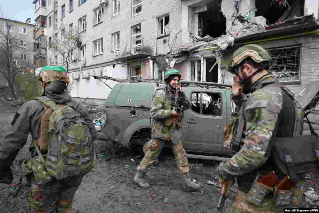 A soldier salutes the victory sign from a colleague in Ukrainian-controlled western Bakhmut. Analysts believe Bakhmut holds little strategic value but has acquired political significance as both sides continue the bloodiest infantry battle since World War II.
