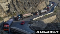 د پېښور او ننګرهار ترمینځ پر لویه لاره له تورخم سره نېږدې یوشمېر مال وړونکي ګاډي ولاړ دي - پخوانی انځور.