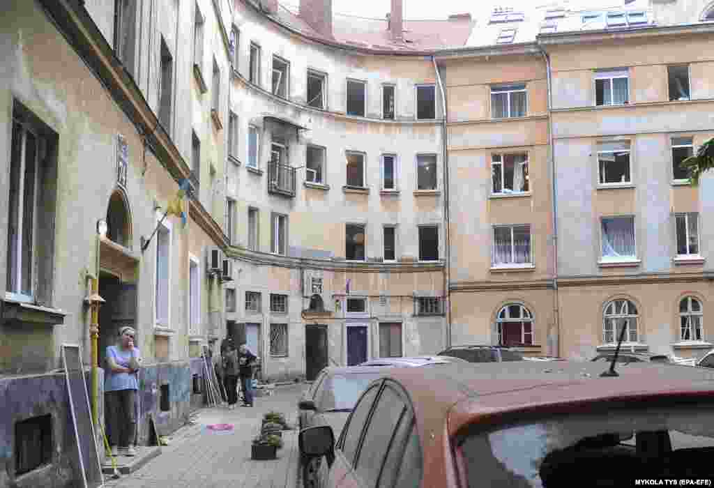 A woman watches as rescue workers continue their search for survivors. Hundreds of thousands of Ukrainian war refugees have sought safety in Lviv from other areas of the war-torn country.