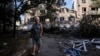 A woman walks near heavily damaged residential buildings in the frontline town of Toretsk in Ukraine's Donetsk region on June 13. 