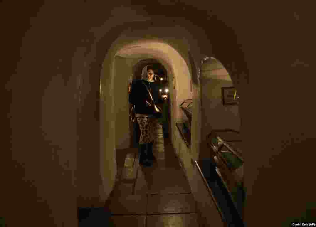 A woman viewing mummified monks in the catacombs of the monastery on February 5, 2023. Passersby who spoke to AFP on March 14 were largely supportive of the ordered eviction, with one saying, &ldquo;If they are pro-Moscow, they&rsquo;re not welcome here." A monk told the French news agency: &ldquo;Many of the fathers, the monks, simply don't have anywhere except the lavra. It's our home. And for us, this [eviction notice] was a bolt from the blue."