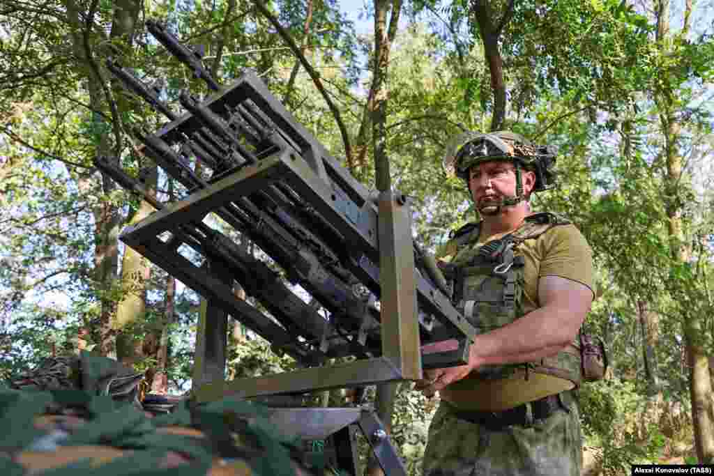 A Russian fighter with an improvised anti-drone gun apparently made up of five AK-74 rifles fitted with trigger bars that fire all the guns simultaneously. The weapon array was photographed in Ukraine&rsquo;s Kherson region in June.
