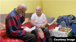 Reghina Boghio și partenerul ei, Sorin Țurcanu, verifică documentele Reghinei