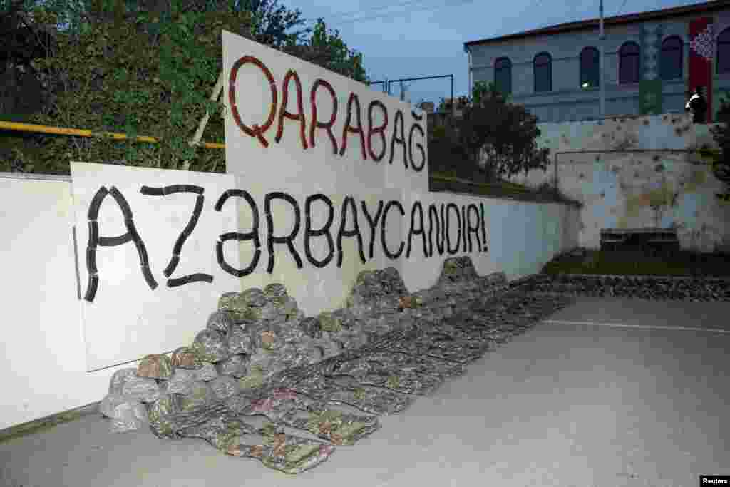Uniforms of ethnic Armenian soldiers displayed under a sign made with automatic rifle magazines says "Karabakh is Azerbaijan!" in Susa, known as Shushi in Armenian. The military of the separatist region began to be disbanded after a September 20 agreement was reached between Azerbaijan and ethnic Armenian authorities.&nbsp;