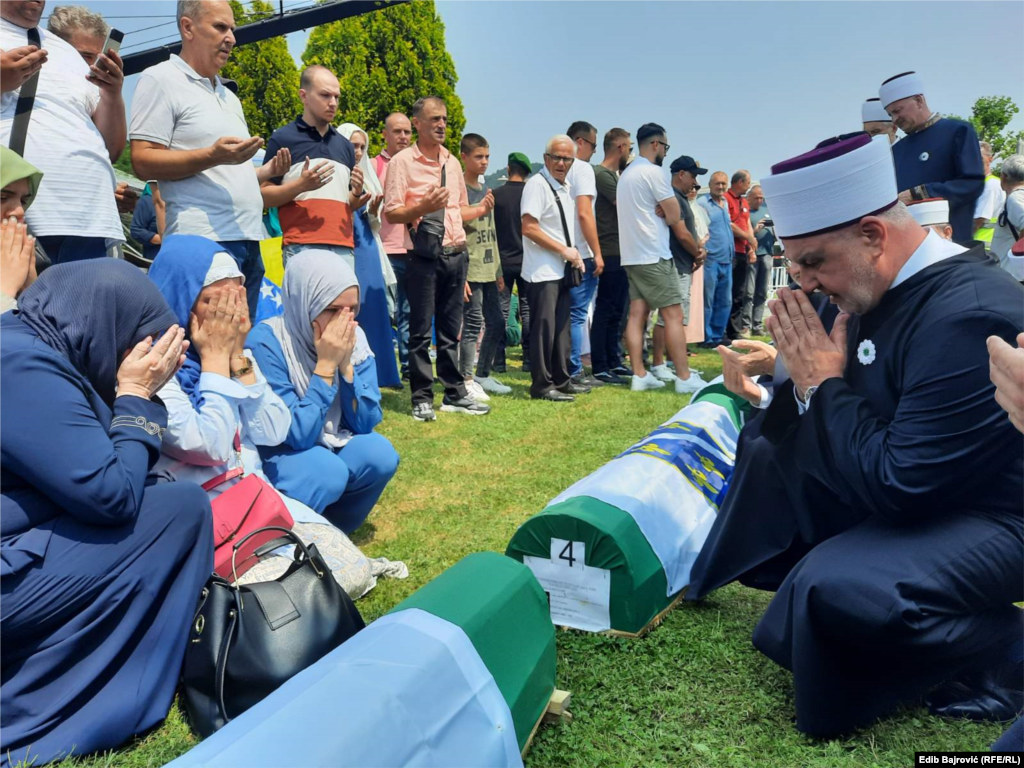 Bosnian Grand Mufti Efendi prays with the families as their relatives' coffins await burial. &nbsp;