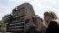 Një grua qëndron pranë ndërtesës së Shtabit të Përgjithshëm të ushtrisë jugosllave, e bombarduar nga NATO-ja më 1999, në Beograd, 15 qershor 2006.