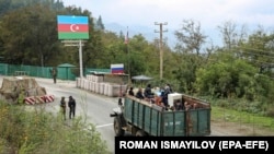 Ethnic Armenians flee Karabakh for Armenia sitting in a truck at the Lachin checkpoint controlled by Russian peackeepers and Azeri border guards, 26 September 2023. 