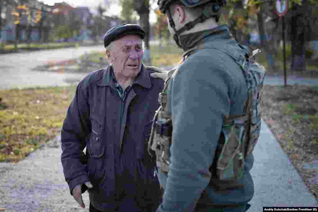 A man cries as he tells Ukrainian soldiers, "Don't leave us again, I'm begging you." These photos were taken by veteran Ukrainian conflict photojournalist Andriy Dubchak as he accompanied Ukrainian forces advancing south toward Kherson.&nbsp;