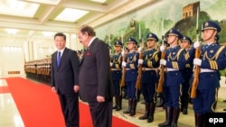 FILE: Pakistani President Mamnoon Hussain (C) attends a welcoming ceremony with Chinese President Xi Jinping (L) in Beijing (February 19, 2014).