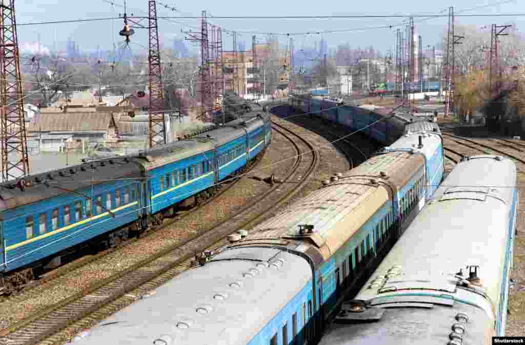 Trains on tracks that run alongside the coast near Mariupol station before the 2022 invasion. The Azovstal factory is visible in the background.&nbsp;