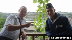 Dmitry Shkrebets (left) with his son, Yegor, who has been "missing" since Russia's Moskva battleship sank in the Black Sea in April. 