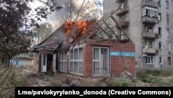 A house burns following strikes on the eastern town of Avdiivka on October 12.