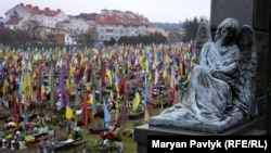 The Lychakiv Cemetery in Lviv is filled with Ukrainian flags and portraits of young soldiers.