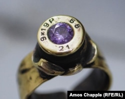 A bejeweled ring made from a 9mm pistol round