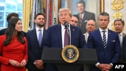 US President Donald Trump, surrounded by senior officials, speaks at the White House on September 2
