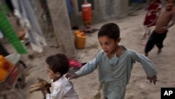 Internally displaced children play at a refugee camp in Kabul in early August.