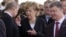 Владимир Путин, Ангела Меркель и Петр Порошенко на торжествах в Нормандии, июнь 2014 года