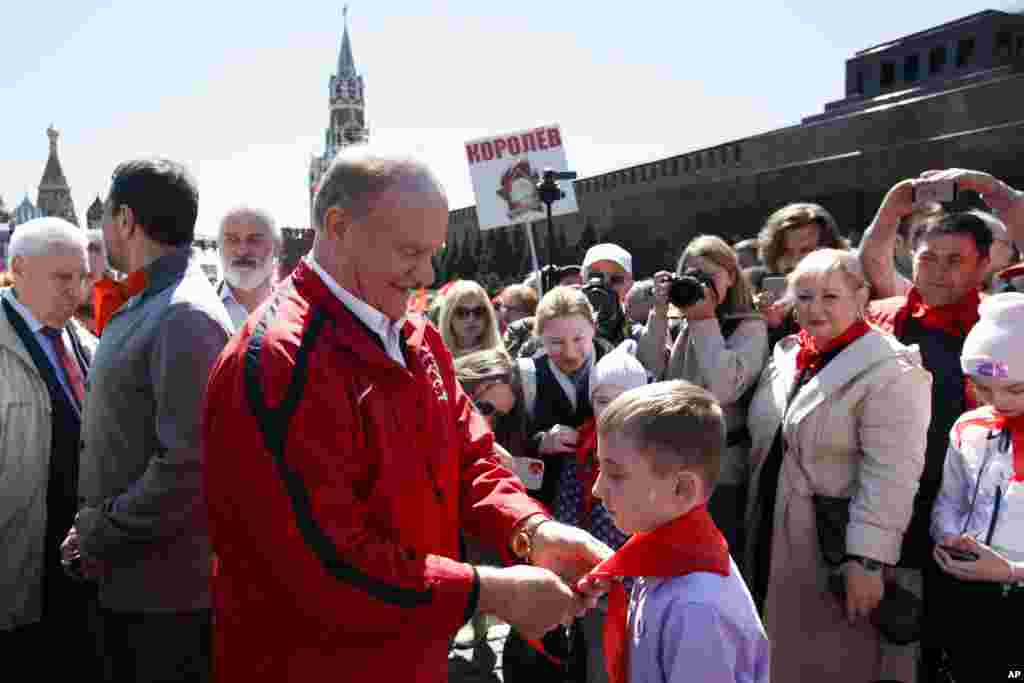 Communist Party leader Gennady Zyuganov (left) ties a red neckerchief to a boy being inducted into the All-Russian Young Pioneers on May 22.&nbsp; It is unclear what purpose the new youth organization will serve, but a Communist Party leader told Russian media that "maximum attention" would be paid to the initiative.&nbsp; &nbsp;