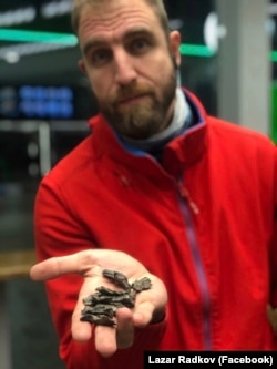 Radkov shows some of the the shrapnel fragments recovered from the bus and its surroundings.