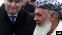 File photo of Ismail Khan with a Tajik official.