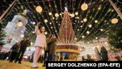 Holiday shoppers take a selfie in front of St. Sophia's Cathedral in Kyiv.