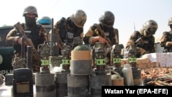 Afghan National Directorate of Security officers display weapons and ammunition seized during operations against Taliban militants, in Helmand on February 18. The UN says that violence in Afghanistan has increased in recent months.