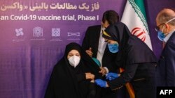 A woman receives an injection during the first trial phase of a locally made Iranian vaccine for COVID-19 in the capital, Tehran, on December 29.