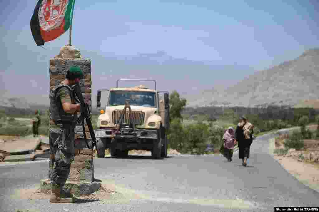 An Afghan soldier watches from a checkpoint in Laghman Province on July 8 after Afghanistan's security forces reportedly cleared the area of Taliban militants.&nbsp; &nbsp;