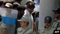Former Pakistani President Pervez Musharraf (center) was escorted by soldiers as he arrived in court in Islamabad on April 12.