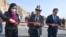 The chairman of the Kyrgyz Cabinet of Ministers, Akylbek Japarov (center), and Chinese Ambassador to Kyrgyzstan Du Dawen (left) open a bridge on November 11 to mark the completion of part of a highway project, just one of many infrastructure ventures in the region that receive support from Beijing. 
