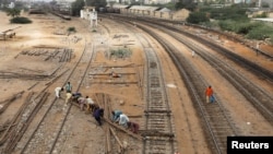 Labourers from the Pakistan Railways are seen working on railway tracks along City Station in Karachi, Pakistan on September 24.