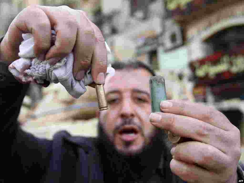 A man displays empty bullet casings in Cairo’s central Tahrir Square on January 29.