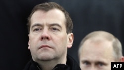 Russia -- President Dmitry Medvedev (L) and Prime Minister Vladimir Putin review honor guards after laying a wreath at the Tomb of the Unknown Soldier near the Kremlin wall in Moscow, 23Feb2011