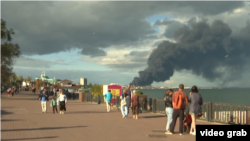 Вид с набережной Феодосии на горящую после атаки ВСУ нефтебазу, 7 октября 2024 года