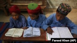 Pakistani children read the Koran at a madrasah in Karachi in November.