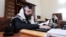 A man swathed in a tallit, or Jewish prayer shawl, reads a religious book at a synagogue in Baku. (file photo)