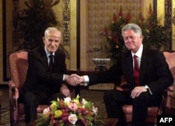 Then-US President Bill Clinton (right) meets his Syrian counterpart, Hafez al-Assad, in Geneva in March 2000