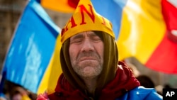 A supporter of banned candidate Calin Georgescu attends a protest in Bucharest in February.